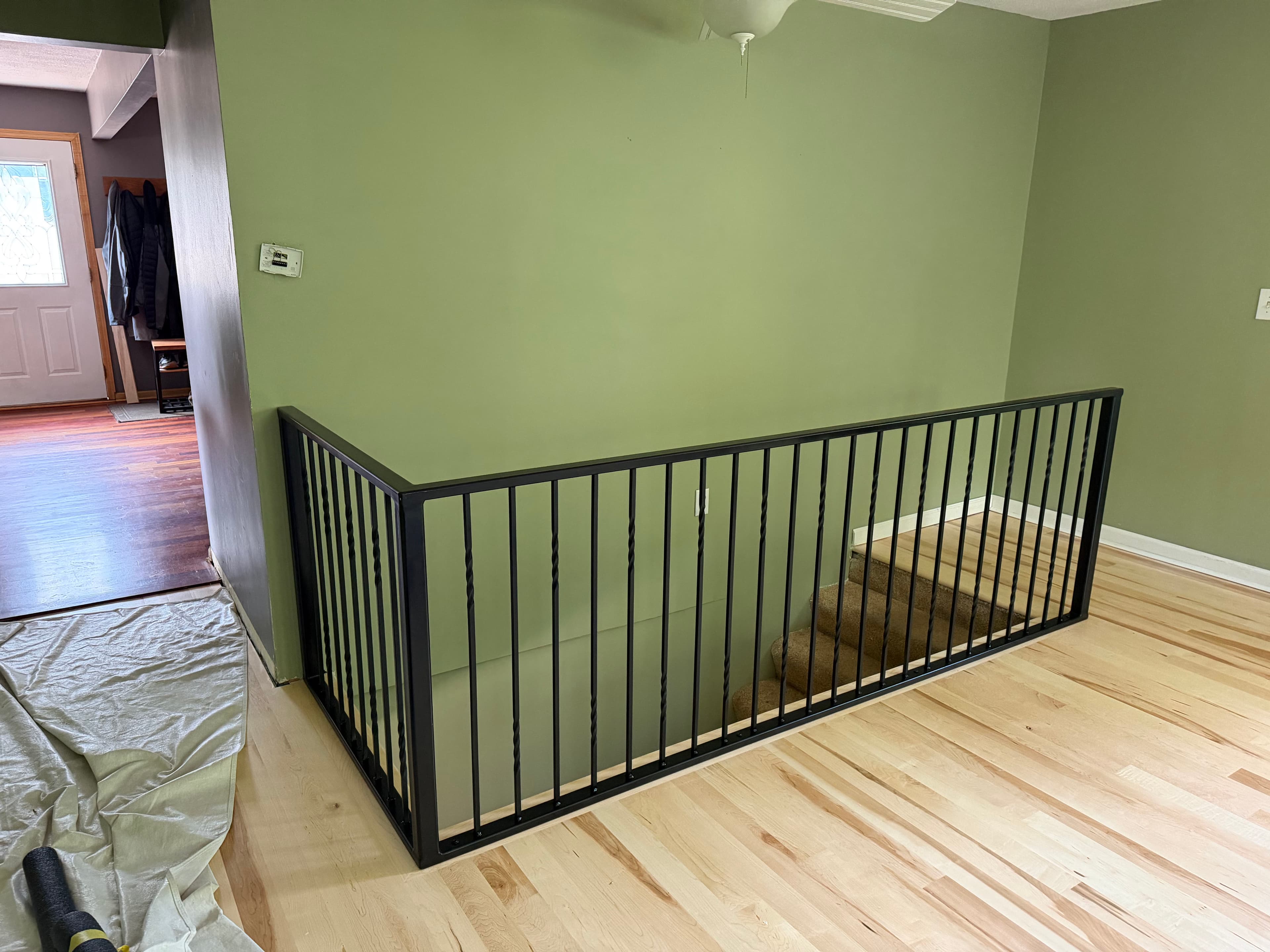 Project Custom Interior Metal Railing Wraps a Staircase Opening Clean image