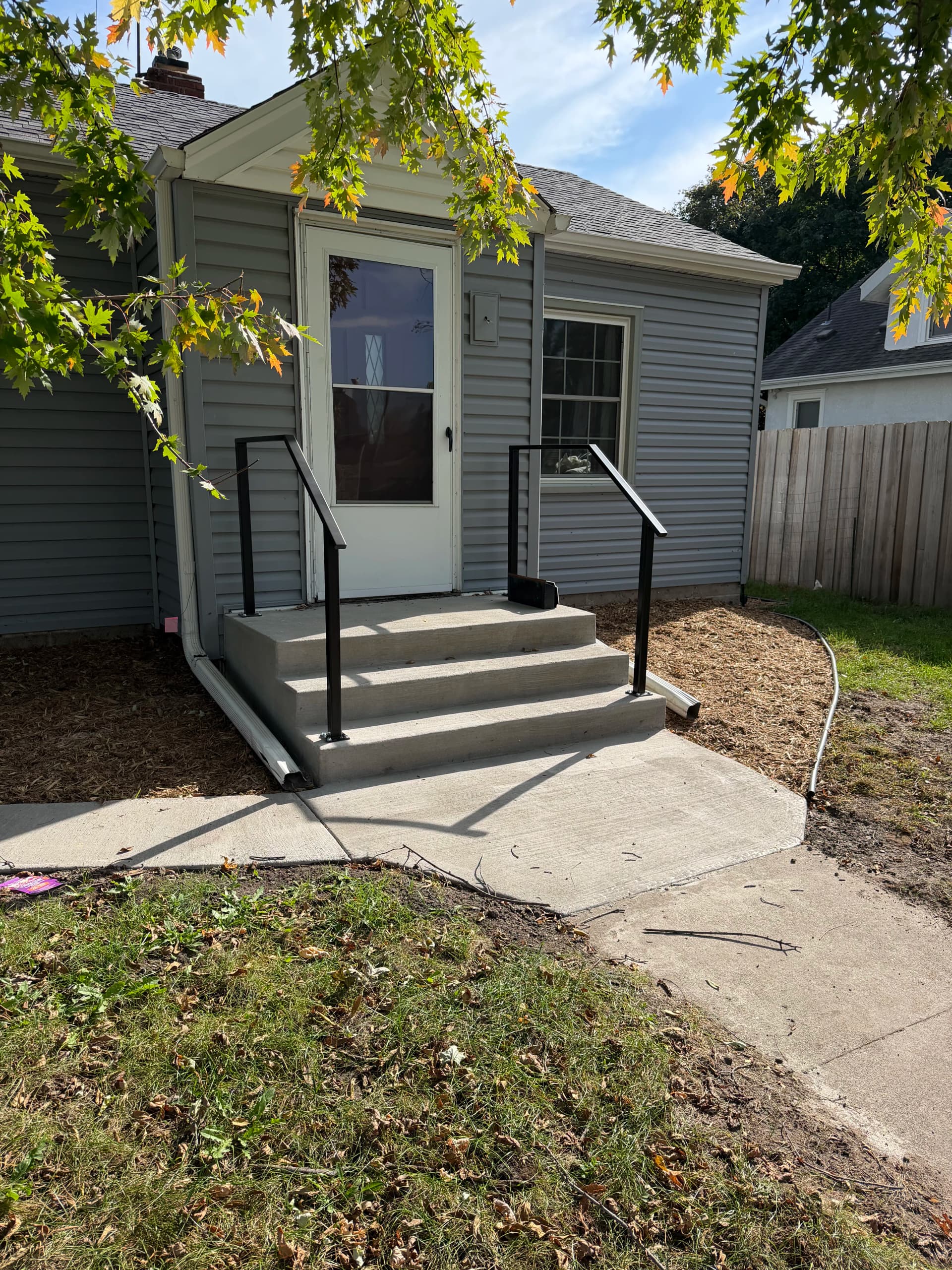 Steel Handrail Install on Concrete Steps in St. Paul image